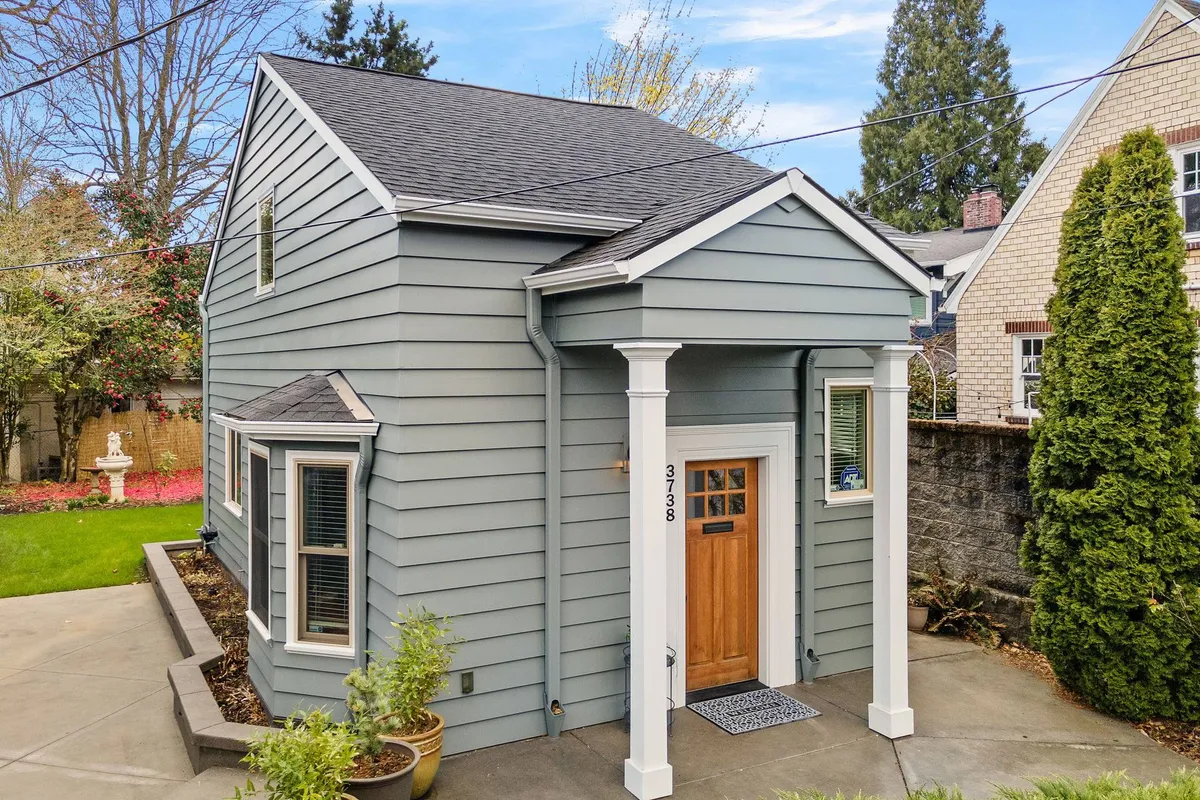 This image captures the front porch area, complete with comfortable outdoor seating, thoughtfully arranged landscaping, and an inviting entry. It offers a glimpse of how residents might enjoy quiet moments before exploring the neighborhood.