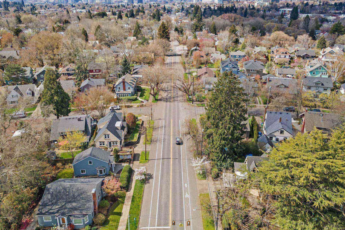This scenic view captures a tree-lined street adorned with mature greenery and classic Portland homes. The peaceful ambiance suggests a pedestrian-friendly, community-oriented environment—ideal for leisurely strolls and daily adventures.